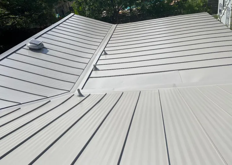 Solar attic fan installed on a metal roof for Roof Ventilation in Riga